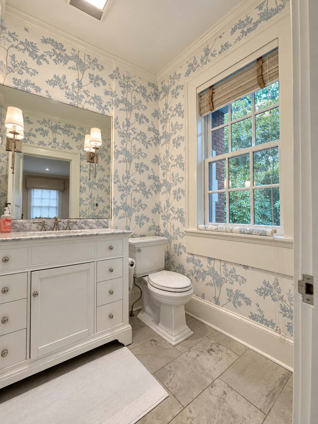Bright white-and-blue floral wallpaper installation in a powder room in Asheville NC