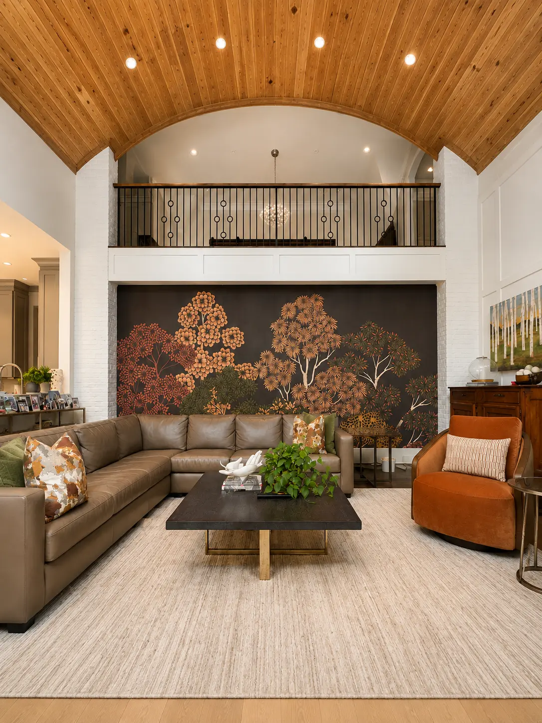 Dark botanical tree mural installation on a two-story living room wall in Asheville NC